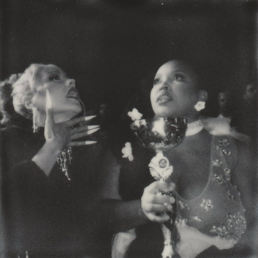 Two people looking up, one holding a trophy